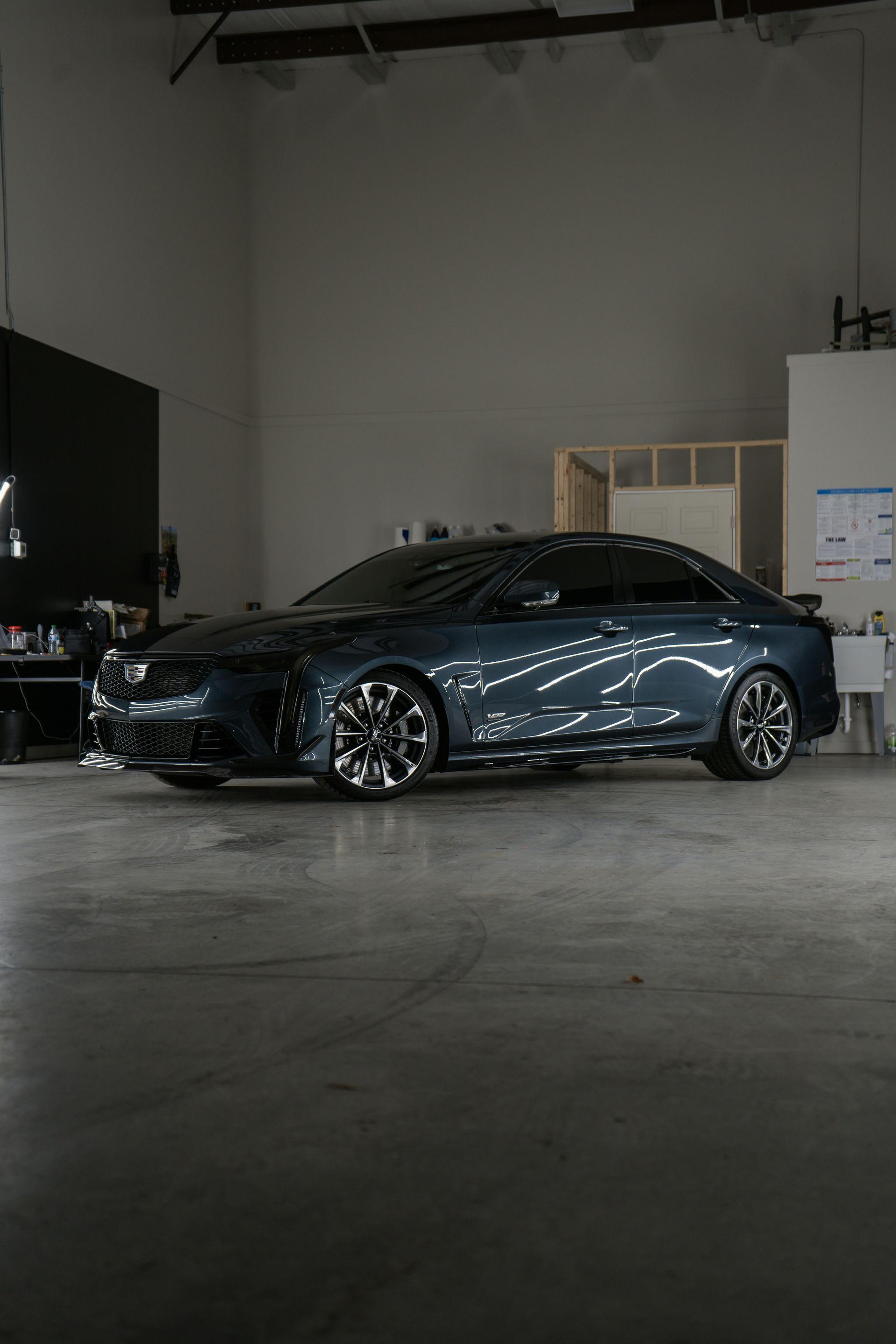 A car parked inside of a garage next to a wall